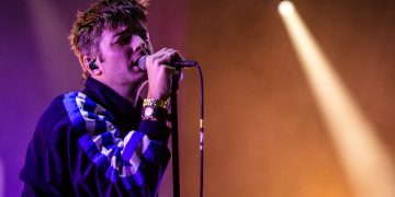 CRICKHOWELL, UNITED KINGDOM - AUGUST 22: Grian Chatten of Fontaines D.C. performs on the Mountain Stage during the 2021 Green Man Festival on August 22, 2021 in Crickhowell, United Kingdom. The festival, which takes place in the Brecon Beacons, was confirmed to go ahead last month after the Welsh Government announced that it would be easing many covid restrictions. More than half of UK festivals are thought to have been cancelled this year. (Photo by Polly Thomas/Getty Images)